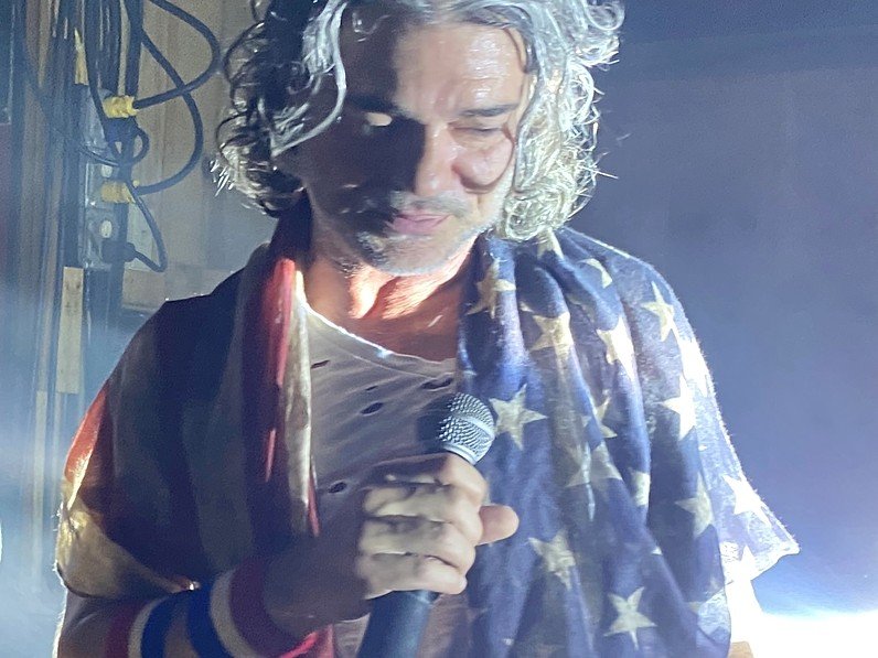 Spank The Monkey vocalist performing with American flag styling